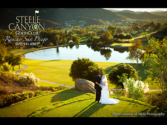 bride and groom sharing kiss on hill of course green, overlooking the pond